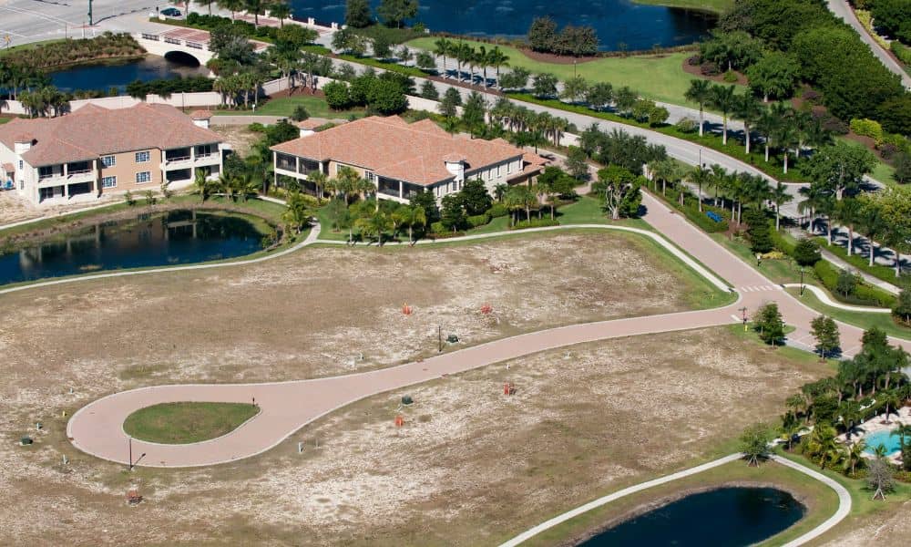 Aerial view of land parcels in a growing neighborhood where developers need ALTA Land Title Surveys before construction
