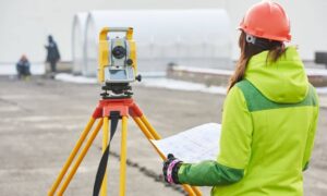 Alta title survey field measurement landscape 1 - ALTA SURVEY Denver Land surveyor using a total station to measure and verify ground distances for an ALTA Title Survey.
