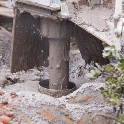 Close-up of a drilling rig collecting a ground sample during soil testing before construction