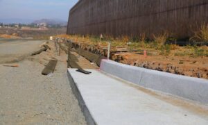 Construction crew forming new curbs and grading a drive-thru lane to support proper drainage design