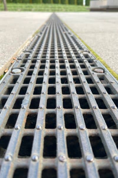 A trench drain installed along a paved surface showing how drainage design helps guide water away from drive-thru areas