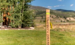 Property corner stake showing where a land survey for fence planning confirms the true boundary