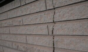 Brick wall foundation crack - ALTA SURVEY Denver Crack in brick wall caused by shifting soil under the foundation