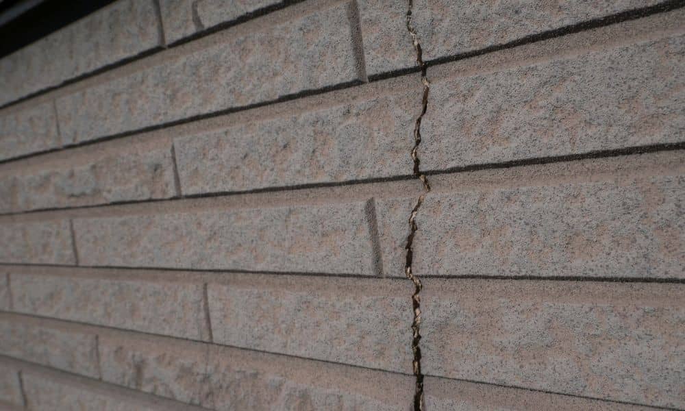 Brick wall foundation crack - ALTA SURVEY Denver Crack in brick wall caused by shifting soil under the foundation
