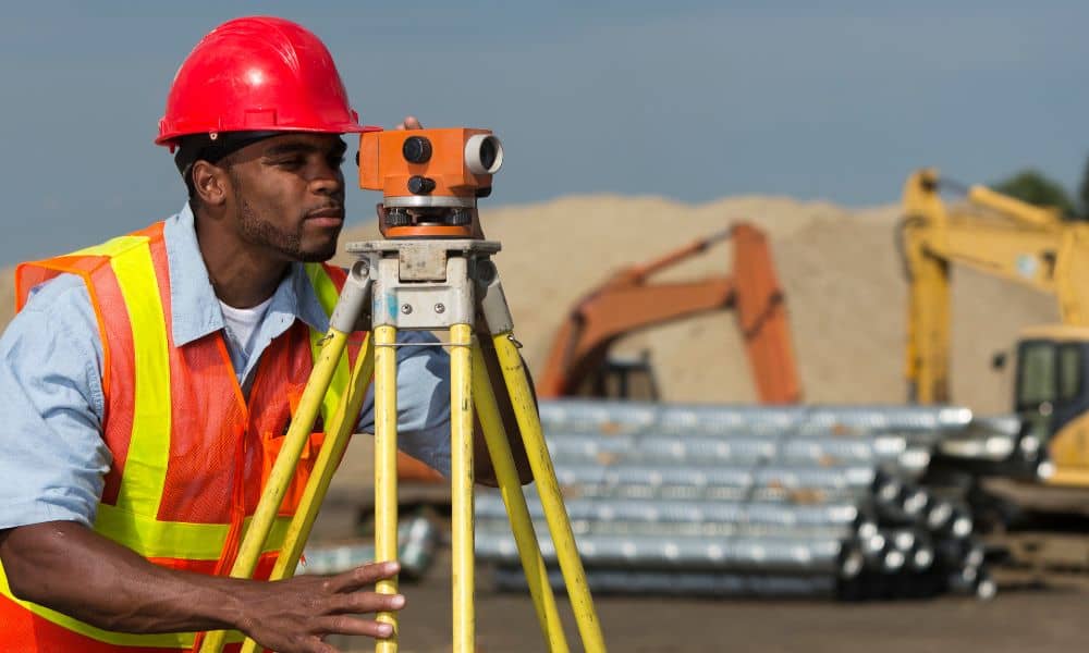 Land surveyor measuring construction site - ALTA SURVEY Denver Land surveyor measuring a construction site, work commonly performed by surveying companies before building begins